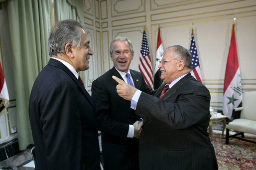 President George W. Bush shakes hands with Iraqi President Jalal Talabani, right, during his visit Tuesday, June 13, 2006, to the U.S. Embassy in Baghdad. With them is U.S. Ambassador to Iraq Zalmay Khalilzad. White House photo by Eric Draper