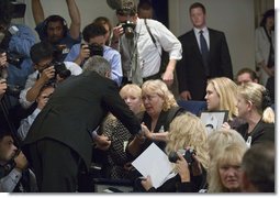 President George W. Bush greets family members of miner Marty Bennett during the signing of S. 2803, The MINER Act, in the Dwight D. Eisenhower Executive Office Building Thursday, June 15, 2006. Mr. Bennett died in the Sago Mine disaster in West Virginia. White House photo by Eric Draper