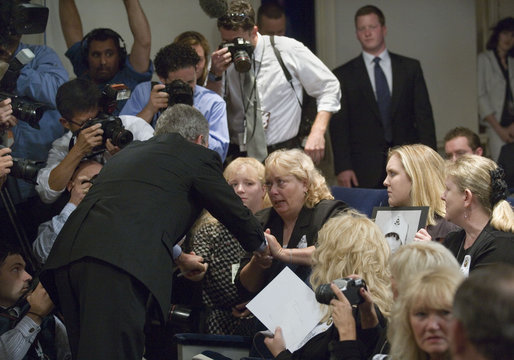 President George W. Bush greets family members of miner Marty Bennett during the signing of S. 2803, The MINER Act, in the Dwight D. Eisenhower Executive Office Building Thursday, June 15, 2006. Mr. Bennett died in the Sago Mine disaster in West Virginia. White House photo by Eric Draper