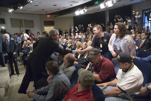 Audience and family members greet President George W. Bush during the signing of S. 2803, The MINER Act, in the Dwight D. Eisenhower Executive Office Building Thursday, June 15, 2006. White House photo by Eric Draper