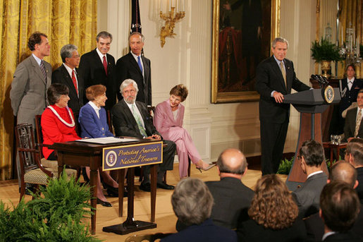 President George W. Bush addresses invited guests in the East Room of the White House prior to signing a proclamation to create the Northwestern Hawaiian Islands Marine National Monument, Wednesday, June 15, 2006.The proclamation will bring nearly 140,000 square miles of the Northwestern Hawaiian Island Coral Reef Ecosystem under the nation's highest form of marine environmental protection. Mrs. Laura Bush joined the President and distinguished guests on stage, seated from left to right, Hawaii Gov. Linda Lingle; marine biologist Sylvia Earle; and documentary filmmaker Jean-Michel Cousteau, Standing ,left to right, are U.S. Rep. Ed Case, D-Hawaii; U.S. Sen. Daniel Akaka, D-Hawaii; U.S. Commerce Secretary Carlos Gutierrez and U.S. Interior Secretary Dirk Kempthorne. White House photo by Shealah Craighead