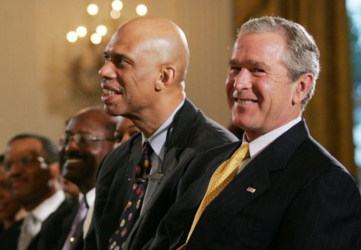 President George W. Bush is joined by basketball Hall of Famer Kareem Abdul Jabbar in the East Room of the White House Monday, June 26, 2006, as they listen to performer Patti Austin at the Black Music Month celebration focusing on the music of the Gulf Coast: Blues, Jazz and Soul. White House photo by Eric Draper