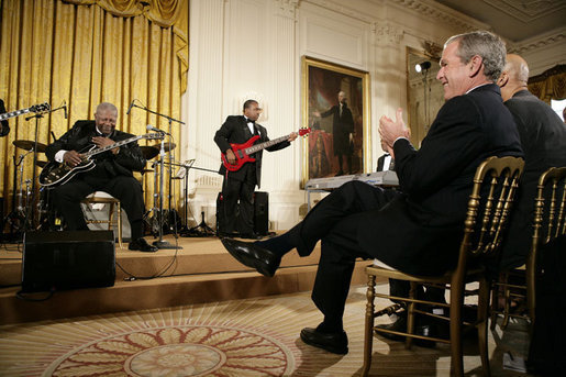 Legendary Blues guitarist B.B. King is applauded by President George W. Bush during King's performance in the East Room of the White House Monday, June 26, 2006, as part of the Black Music Month celebration focusing on the music of the Gulf Coast: Blues, Jazz and Soul. White House photo by Eric Draper