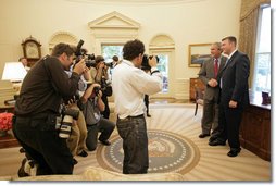 President George W. Bush meets with U.S. Army Staff Sergeant Christian Bagge, 23, of Eugene, Ore., in the Oval Office Tuesday, June 27, 2006. Mr. Bagge lost both legs to a roadside bomb in Iraq while serving in Operation Iraqi Freedom. After their meeting, the two ran together on the South lawn. White House photo by Eric Draper