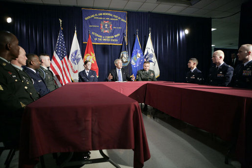 President George W. Bush sits with U.S. Air Force Senior Airman Rebecca Blascak, left, and U.S. Army Sgt. First Class Kenneth Williams, right, as he meets with military personnel Wednesday, June 28, 2006, at the VFW Overland-St. Ann Memorial Post #3944 in St. Louis, Mo., who recently have returned from Iraq and Afghanistan. White House photo by Kimberlee Hewitt