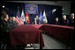 President George W. Bush sits with U.S. Air Force Senior Airman Rebecca Blascak, left, and U.S. Army Sgt. First Class Kenneth Williams, right, as he meets with military personnel Wednesday, June 28, 2006, at the VFW Overland-St. Ann Memorial Post #3944 in St. Louis, Mo., who recently have returned from Iraq and Afghanistan. White House photo by Kimberlee Hewitt