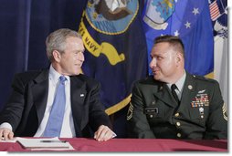 President George W. Bush talks with U.S. Army Sgt. First Class Kenneth Williams, as he meets with military personnel Wednesday, June 28, 2006, at the VFW Overland-St. Ann Memorial Post #3944 in St. Louis, Mo., who recently have returned from Iraq and Afghanistan. White House photo by Kimberlee Hewitt