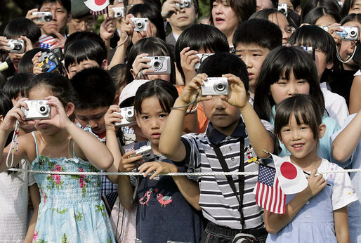 President George W. Bush and Prime Minister Junichiro Koizumi of Japan are greeted by an enthusiastic crowd of young guests during an arrival ceremony on the South Lawn Thursday, June 29, 2006. White House photo by Eric Draper