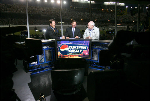 Vice President Dick Cheney talks with Chris Myers, left, and Jeff Hammond, center, of Fox Sports Network, Saturday, July 1, 2006, during a live TV interview held during the 2006 Pepsi 400 NASCAR race at Daytona International Speedway in Daytona, Fla. White House photo by David Bohrer