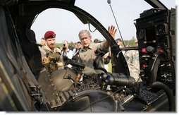 President George W. Bush is shown a helicopter Tuesday, July 4, 2006, during his Independence Day visit to Fort Bragg in North Carolina, where he addressed troops and met with the U.S. Army Special Operations Command. White House photo by Paul Morse