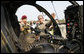 President George W. Bush is shown a helicopter Tuesday, July 4, 2006, during his Independence Day visit to Fort Bragg in North Carolina, where he addressed troops and met with the U.S. Army Special Operations Command. White House photo by Paul Morse