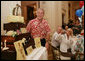 President George W. Bush is presented with a birthday cake Tuesday evening, July 4, 2006, during a dinner party at the White House. President Bush will celebrate his 60th birthday on Thursday. White House photo by Shealah Craighead