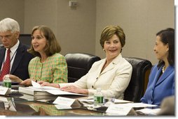 Mrs. Laura Bush smiles at Dina Hibab Powell, Deputy Under Secretary for Public Diplomacy, Public Affairs and Assistant Secretary of State for Educational and Cultural Affairs during the fifth meeting of the U.S. Afghan Women's Council at the State Department, Wednesday, July 5, 2006, in Washington, D.C. Also shown are Dr. Paula Dobrianksy, Under Secretary of State for Democracy and Global Affairs, left, and James Kunder, Assistant Administrator for Asia and the Near East, USAID. White House photo by Shealah Craighead