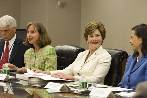 Mrs. Laura Bush smiles at Dina Habib Powell, Deputy Under Secretary for Public Diplomacy, Public Affairs and Assistant Secretary of State for Educational and Cultural Affairs during the fifth meeting of the U.S. Afghan Women's Council at the State Department, Wednesday, July 5, 2006, in Washington, D.C. Also shown are Dr. Paula Dobrianksy, Under Secretary of State for Democracy and Global Affairs, left, and James Kunder, Assistant Administrator for Asia and the Near East, USAID. White House photo by Shealah Craighead