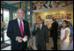 President George W. Bush offers to buy a cup of coffee for a member of the media during a stop at Dunkin' Donuts in Alexandria, Va., July 5, 2006. "We need to make sure we help people assimilate. I met four people here who assimilated into our country. They speak English; they understand the history of our country; they love the American flag as much as I love the American flag," said the President. "That's one of the great things about America, we help newcomers assimilate. Here's four folks that are living the American Dream, and I think it helps renew our soul and our spirit to help people assimilate." White House photo by Kimberlee Hewitt