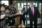 President George W. Bush offers to buy a cup of coffee for a member of the media during a stop at Dunkin' Donuts in Alexandria, Va., July 5, 2006, where President Bush spoke in support of the Basic Pilot Program to verify employment eligibility. White House photo by Kimberlee Hewitt