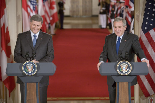 President George W. Bush and Canadian Prime Minister Stephen Harper hold a joint press conference in the East Room Thursday, July 6, 2006. "The President and I have agreed to task our officials to provide a more forward-looking approach focused on the environment, climate change, air quality and energy issues in which our governments can cooperate," said Prime Minister Harper. "We raised the issue of how regulatory cooperation could increase productivity, while helping to protect our health, safety, and environment." White House photo by Kimberlee Hewitt