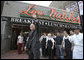 President George W. Bush waves as he leaves Lou Mitchell’s Restaurant in Chicago, Friday, July 7, 2006, following a breakfast meeting with local business leaders at the restaurant. White House photo by Kimberlee Hewitt