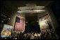 President George W. Bush speaks beneath a replica of the Wright Brother’s plane as he addresses a news conference at the Museum of Science and Industry in Chicago, Friday, July 7, 2006, speaking on the economy, immigration reform and security issues. White House photo by Eric Draper