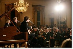 President George W. Bush, Mrs. Laura Bush and guests listen to the band Rascal Flatts in the East Room of the White House following a dinner honoring the Special Olympics and founder Eunice Kennedy Shriver, Monday, July 10, 2006. White House photo by Shealah Craighead