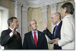 President George W. Bush attends the swearing in of Henry Paulson as the Secretary of Treasury by Supreme Chief Justice John Roberts at the Department of the Treasury Monday, July 10, 2006.  White House photo by Eric Draper