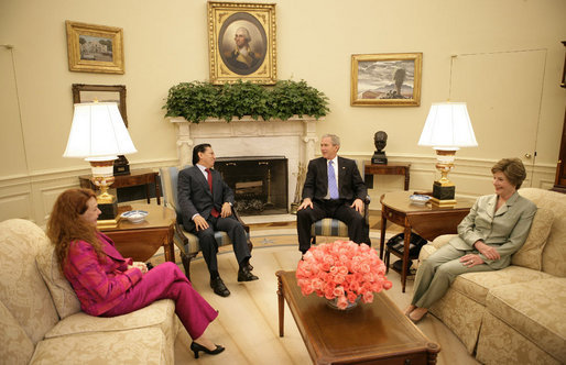 President George W. Bush and Mrs. Laura Bush visit with President Alejandro Toledo of Peru, and his wife and advisor, Mrs. Eliane Karp de Toledo, during a photo opportunity Tuesday, July 11, 2006, in the Oval Office. White House photo by Eric Draper