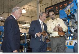 President George W. Bush watches how a shoe heel is formed at the Allen-Edmonds Shoe Corporation in Port Washington, Wis., Tuesday, July 11, 2006. After touring the company, President Bush addressed the press, "So the tax cuts we passed have helped this company. It made a lot of sense. They've also helped our country. This economy of ours is growing. The unemployment rate is 4.6 percent nationally." White House photo by Kimberlee Hewitt