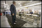 President George W. Bush shows off his new red, white and blue shoes that were presented to him during his visit to the Allen-Edmonds Shoe Corporation in Port Washington, Wis., Tuesday, July 11, 2006. "I'm thrilled with my new shoes," said the President to the press. "I wish I had them on the Fourth of July." White House photo by Kimberlee Hewitt