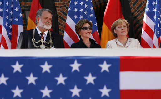 Mrs. Laura Bush is seated between Stralsund Mayor Harald Lastovka and German Chancellor Angela Merkel during the welcoming ceremony Thursday, July 13, 2006, in honor of the visit by President George W. Bush and Laura Bush to Stralsund, Germany. White House photo by Eric Draper