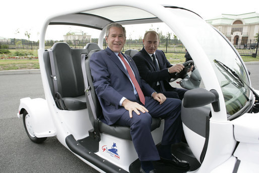 President George W. Bush is escorted by President Vladimir Putin of Russia, as they drive an electric GEM car to the Bilateral Meeting Room at the Konstantinovsky Palace Complex, site of the G8 Summit Saturday, July 15, 2006, in Strelna, Russia. White House photo by Eric Draper