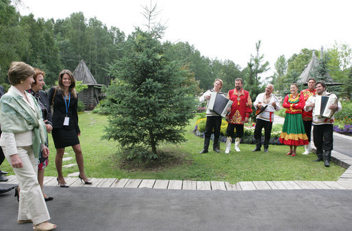 Mrs. Laura Bush and Mrs. Lyudmila Putina are greeted by a traditional Russian Folk group as they arrive at the Podvoriye Restaurant Saturday, July 15, 2006, in St. Petersburg, Russia. White House photo by Shealah Craighead