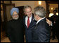 President George W. Bush embraces India’s Prime Minister Dr. Manmohan Singh, left, and Brazilian President Luiz Inacio Lula da Silva, right, at the Konstantinovsky Palace Complex Monday, July 17, 2006. President Bush met with the two leaders separately in bilateral meetings during the G8 Summit in Strelna, Russia. White House photo by Eric Draper