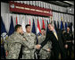 President George W. Bush shakes hands with newly sworn-in American citizens, Specialist Sergio Lopez, 24, of Bolingbrook, Ill., left, Specialist Noe Santos-Dilone of Brooklyn, N.Y., center, and Private First Class Eduardo Leal-Cardenas of Los Angeles, Calif., during their naturalization ceremony Monday, July 24, 2006, at Walter Reed Army Medical Center in Washington, D.C. White House photo by Eric Draper