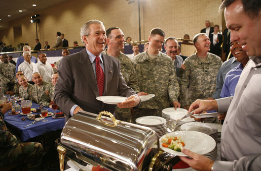 President George W. Bush speaks with military personnel as he makes his way along a buffet line during a visit to Fort Belvoir, Va., Wednesday, July 26, 2006. White House photo by Paul Morse