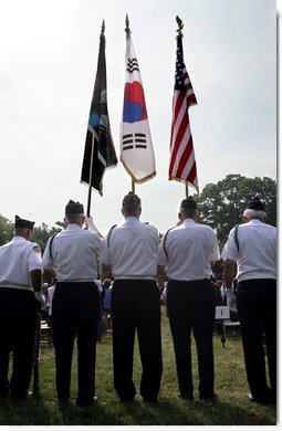 An honor guard composed of Korean War veterans holds flags prior to the start of the 2006 Korean War Veterans Armistice Day Ceremony held at the Korean War Memorial on the National Mall in Washington, D.C., Thursday, July 27, 2006. White House photo by David Bohrer