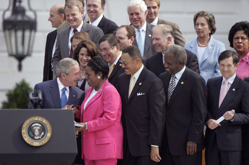 President George W. Bush talks with U.S. Representative Sheila Jackson Lee, D-Texas, during the signing of H.R. 9, the Fannie Lou Hamer, Rosa Parks, and Coretta Scott King Voting Rights Act Reauthorization and Amendments Act of 2006, on the South Lawn Thursday, July 27, 2006. White House photo by Paul Morse