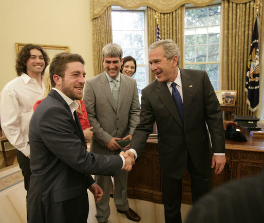 President George W. Bush welcomes Elliott Yamin, one of the top 10 American Idol finalists who arrived late to the Oval Office at the White House Friday, July 28, 2006, along with Yamin’s fellow performers, from left to right, Ace Young, Kelli Pickler, American Idol winner Taylor Hicks and Katharine McPhee. The popular FOX television program, which originated in 2002, uses audience participation to determine the best “undiscovered” young singer in the nation. White House photo by Eric Draper