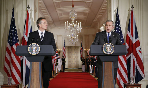 President George W. Bush is joined by Prime Minister Tony Blair of the United Kingdom as he answers a reporter’s question during a joint press availability Friday, July 28, 2006, in the East Room of the White House. White House photo by Paul Morse