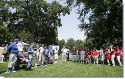 President George W. Bush welcomes players and guests to the White House Sunday, July 30, 2006, for the Tee Ball on the South Lawn game between the Thurmont Little League Civitan Club of Frederick Challengers of Thurmont, Md., and the Shady Spring Little League Challenger Braves of Shady Spring, W. Va. White House photo by Paul Morse