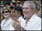 President George W. Bush and Laura Bush are joined by baseball legend and hall of famer Willie Mays, Tee Ball Commissioner for the day Sunday, July 30, 2006, at the Tee Ball on the South Lawn game between the Thurmont Little League Civitan Club of Frederick Challengers of Thurmont, Md., and the Shady Spring Little League Challenger Braves of Shady Spring, W. Va. White House photo by Paul Morse