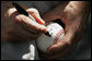 President George W. Bush autographs baseballs for players and guests at the White House Sunday, July 30, 2006, during the Tee Ball on the South Lawn game between the Thurmont Little League Civitan Club of Frederick Challengers of Thurmont, Md., and the Shady Spring Little League Challenger Braves of Shady Spring, W. Va. White House photo by Paul Morse