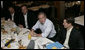 President George W. Bush meets business leaders and his brother, Florida Governor Jeb Bush, left, in Miami at the Versailles Restaurant and Bakery for a breakfast meeting Monday, July 31, 2006. White House photo by Kimberlee Hewitt