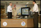 President George W. Bush talks with Max Mayfield, center, director of NOAA's Tropical Prediction Center and National Hurricane Center and with Chris Landsea the Science and Operations Officer at the National Hurricane Center in Miami Monday, July 31, 2006. White House photo by Kimberlee Hewitt