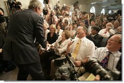 President George W. Bush conveys birthday wishes to reporter Helen Thomas in the James S. Brady Press Briefing Room during its last day of operation before it closes for renovations Wednesday, August 2, 2006.  White House photo by Eric Draper