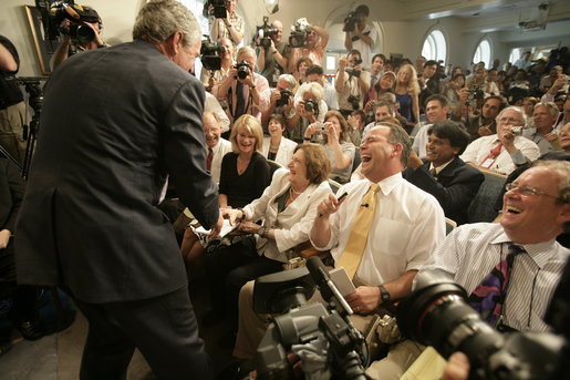 President George W. Bush conveys birthday wishes to reporter Helen Thomas in the James S. Brady Press Briefing Room during its last day of operation before it closes for renovations Wednesday, August 2, 2006. White House photo by Eric Draper