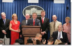 Accompanied by seven White House Press Secretaries, President George W. Bush jokes with reporters Wednesday, August 2, 2006, during the last day of operation of the James S. Brady Press Briefing Room before it undergoes a renovation. On stage with the President are, from left: Joe Lockhart, Dee Dee Myers, Marlin Fitzwater, Tony Snow, Ron Nessen, James Brady and his wife Sarah Brady. White House photo by Shealah Craighead