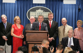 Accompanied by seven White House Press Secretaries, President George W. Bush jokes with reporters Wednesday, August 2, 2006, during the last day of operation of the James S. Brady Press Briefing Room before it undergoes a renovation. On stage with the President are, from left: Joe Lockhart, Dee Dee Myers, Marlin Fitzwater, Tony Snow, Ron Nessen, James Brady and his wife Sarah Brady. White House photo by Shealah Craighead