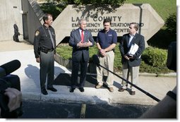 President George W. Bush is joined by Lake County Sheriff Dan Dunlap, left; Larry Greene, director of the Lake County Emergency Management Agency and Jesse Munoz of the Federal Emergency Management Agency, right, as President Bush spoke to reporters Wednesday, Aug. 2, 2006 outside the Lake County Emergency Management Agency facility in Mentor, Ohio, following a meeting on the Lake County flood response following severe storms that caused major flooding in numerous counties in July. White House photo by Kimberlee Hewitt