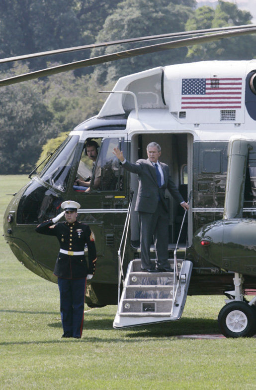 President George W. Bush waves from the steps of Marine One on the South Lawn of the White House Thursday, Aug. 3, 2006, as he departs to visit the U.S.-Mexico border patrol facilities in McAllen and Mission, Texas. White House photo by Kimberlee Hewitt