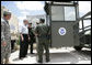 President George W. Bush speaks with members of the National Guard and U.S. Border Patrol officers during his tour along the U.S.-Mexico border Thursday, Aug. 3, 2006, in the Rio Grande Valley border patrol sector in Mission, Texas. White House photo by Eric Draper